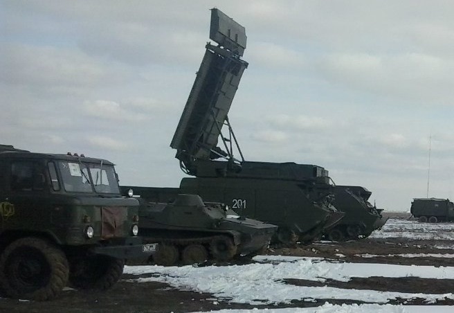 The third vehicle from the left is a Snow Drift Radar that can be used as part of the Buk system. The number on the side reads “201”. [Source]