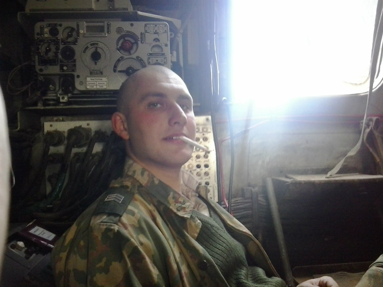 Krasnoproshin inside one of the unit's vehicles. The chevrons indicate that he is a sergeant. [Source]